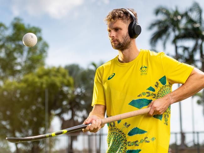 The Kookaburras are in Darwin for training before heading off to Japan for the 2020 Olympics.Josh Beltz warms up with some tunes before a session in the Darwin heat. Picture: Che Chorley