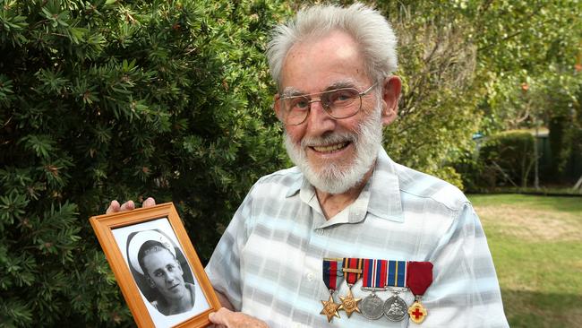 Fred Bottrell with a portrait of himself during his service with the Royal Navy during World War II Picture: Hamish Blair