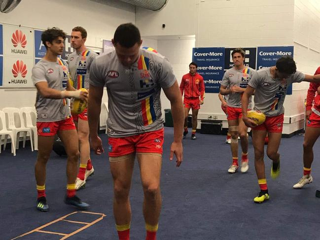 The Gold Coast Suns players in the dressing room ahead of their Round 16 game against North Melbourne at Etihad Stadium. Steven May (front) warming up. Picture: Supplied.