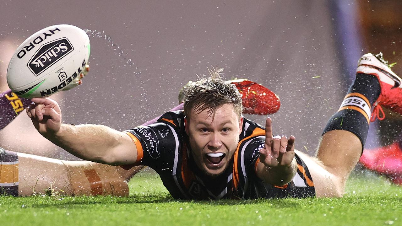 Billy Walters of the Wests Tigers celebrates scoring his first NRL try