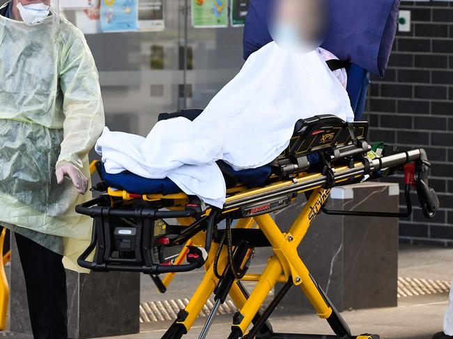 Medical workers evacuate a resident from the Epping Gardens aged care facility in Melbourne. Photo: William WEST / AFP