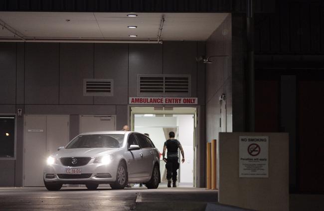 A policeman wearing a bullet proof vest walks into Alice Springs Hospital after Arnold Walker was shot in Yuendumu. Picture: Emma Murray