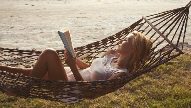 Paradise is reading a book on the beach.