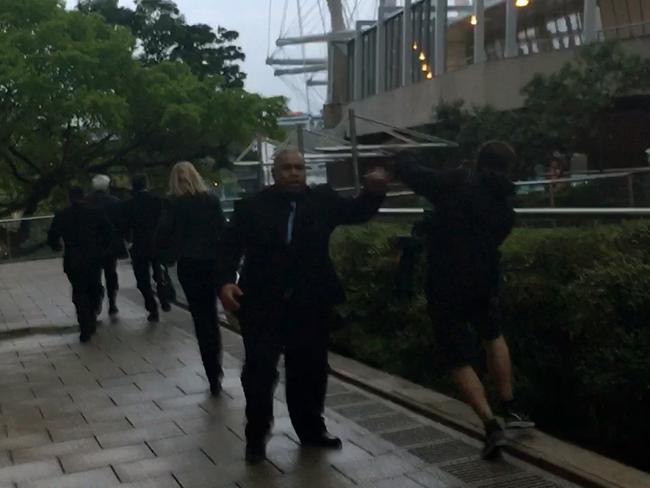 A member of Clive Palmer’s security clashes with a photographer. Picture: AAP