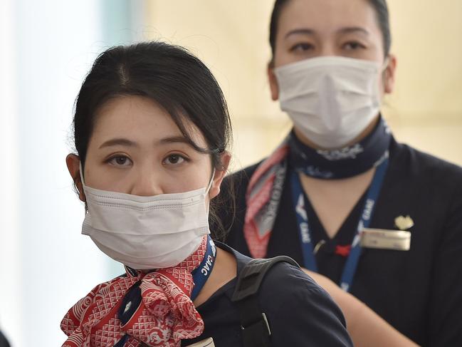 TOPSHOT - China Eastern Airlines aircrew arrive at Sydney airport after landing on a plane from Shanghai on January 25, 2020. - Australian authorities confirmed its first case of a new virus as thousands of people worldwide are treated for the deadly infection (Photo by PETER PARKS / AFP)