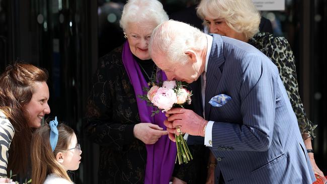 King Charles receives flowers from a little girl as he departs from the University College Hospital Macmillan Cancer Centre. Picture: Getty Images