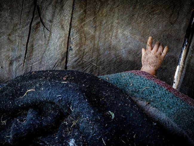 A tiny doll’s hand peeks out from beneath a blanket on on Isla De Las Munecas, Xochimico, Mexico. Picture: Flickr/Kevin