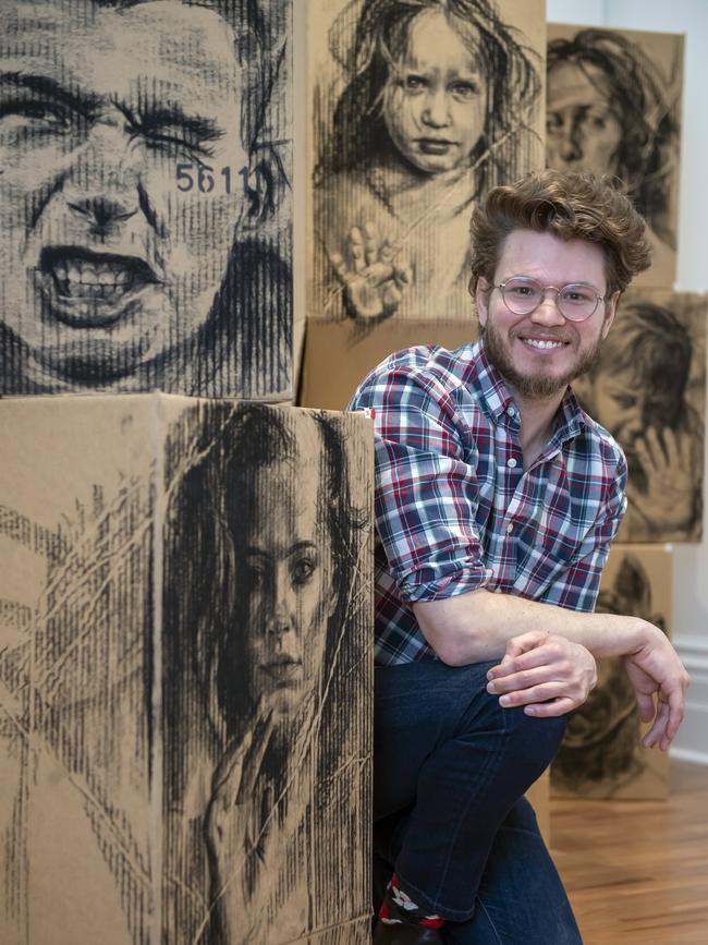 Albert Park artist Daniel Coulson with some of his work at St Kilda Town Hall in St Kilda, Tuesday, July 23, 2019. Picture: Andy Brownbill