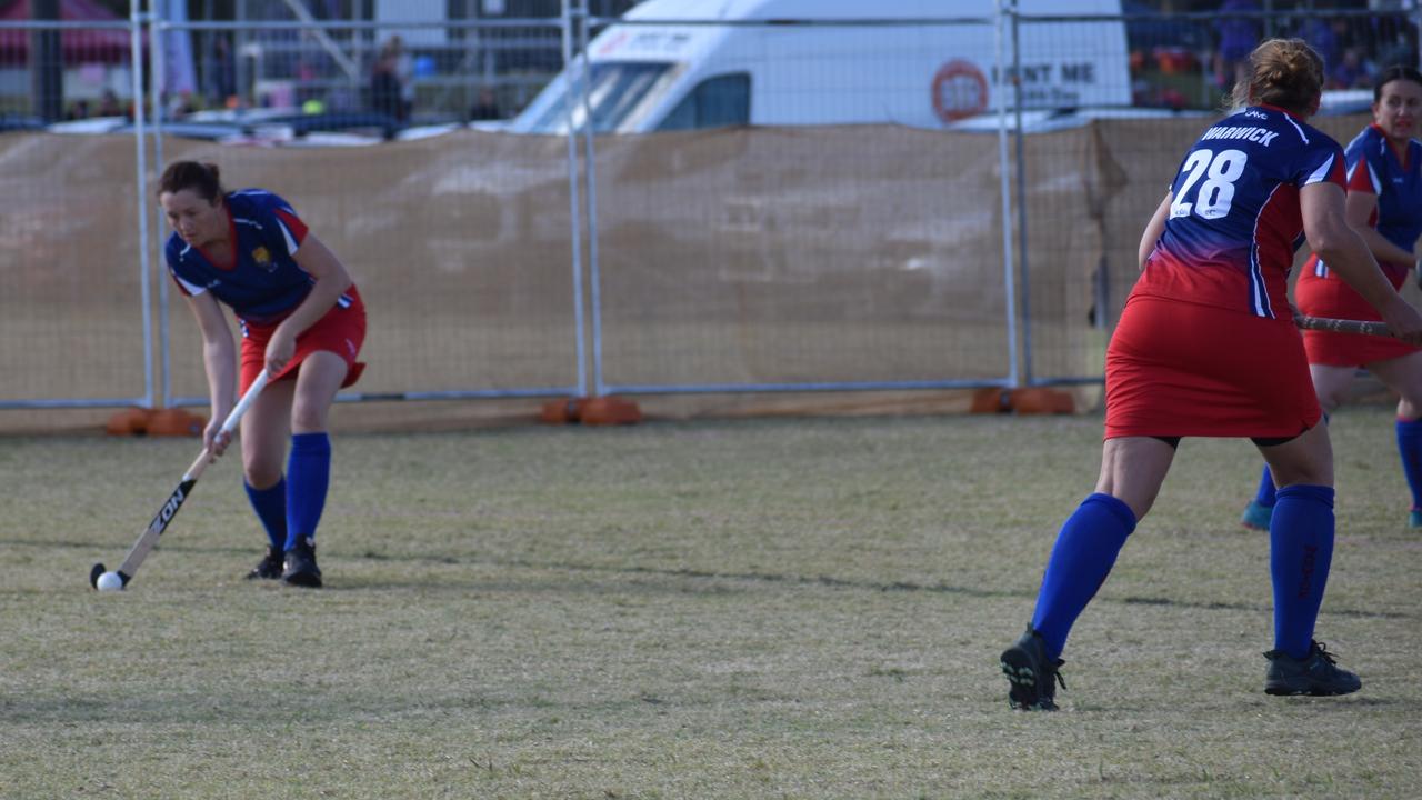 Deborah Rhodes lining up a pass to Warwick teammate Angela Groves in their match-up with Townsville at the 2021 Queensland Hockey Women's Masters Championship at Queens Park.