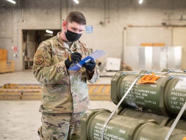 This handout photo courtesy of US Air Force taken on January 21, 2022 shows Staff Sgt. Kyle Davis, 436th Aerial Port Squadron special handling supervisor, counts pallets of ammunition, weapons and other equipment bound for Ukraine during a foreign military sales mission at Dover Air Force Base, Delaware. (Photo by Handout / US Airforce / AFP) / RESTRICTED TO EDITORIAL USE - MANDATORY CREDIT "AFP PHOTO /  Mauricio Campino /US Air Force " - NO MARKETING - NO ADVERTISING CAMPAIGNS - DISTRIBUTED AS A SERVICE TO CLIENTS