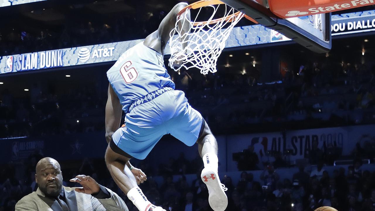Oklahoma City Thunder guard Hamidou Diallo leaps over former NBA player Shaquille O'Neal.