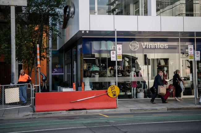 Detectives leave St John’s Youth Services on Waymouth St bags of evidence after a 21-year-old man had been arrested. Picture: AAP / Morgan Sette