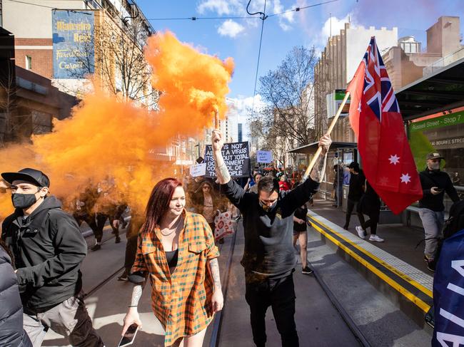 Several members of the crowd set off flares. Picture: Jason Edwards