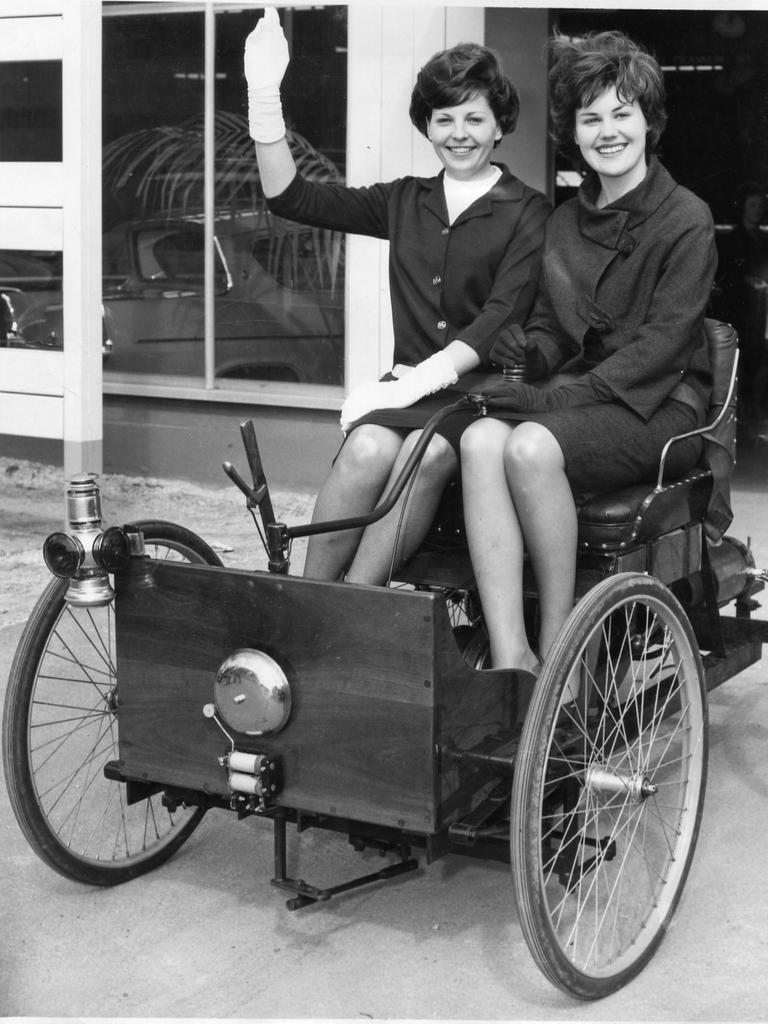 Miss South Australia Quest entrants Margaret Buring (left) and Maria Potiuch wave from the seat of a replica of Henry Ford's quadricycle at Wayville Showgrounds, September, 1963. It will be a feature of the Ford exhibit at the Royal Adelaide Show.