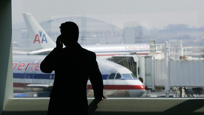 (FILES) In this 27 July 2005 file photo, a man talks on a cell phone in the American Airlines terminal at John F. Kennedy (JFK) International Airport in New York. The FBI is expected to announce 02 June 2007 the arrest of four people in connection with a terror plot against the airport. Media reports say the plot involved a plan to attack jet-fuel pipelines at JFK. Chris Hondros/Getty Images/AFP/FILES =FOR NEWSPAPER, INTERNET, TELCOS AND TELEVISION USE ONLY=ONLY