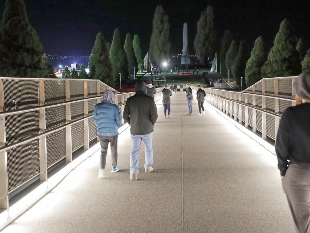 People cross Hobart's new Bridge of Remembrance on their way to the Anzac Day dawn service in Hobart. Picture: PATRICK GEE