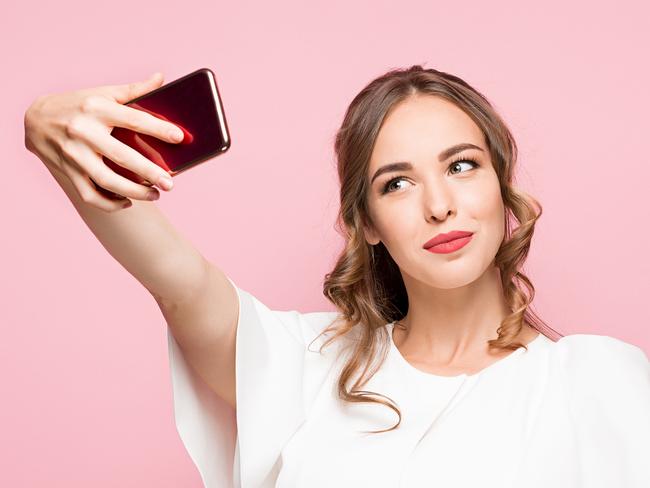 A woman talking a selfie on her smartphone or mobile phone. Picture: iStock.