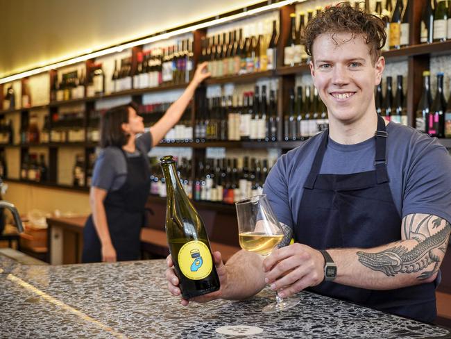 Leigh Street Wine Room manager Lewis McDonald and assistant manager Alejandra Canel (back). Photo: AAP/Mike Burton