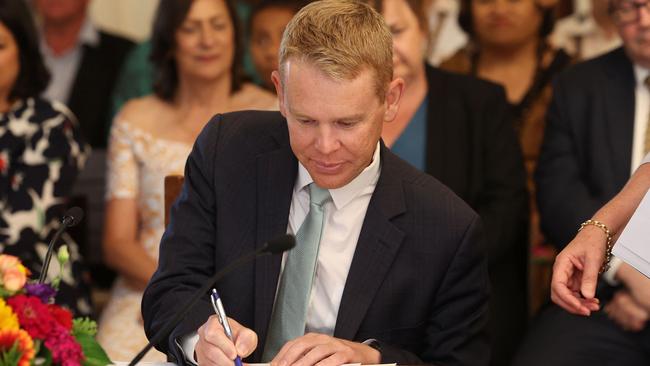 Chris Hipkins signs his commission after being sworn in by Governor-General Cindy Kiro in Wellington on Wednesday. Picture: AFP