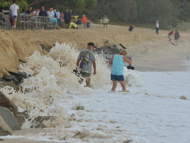 People try to walk down Noosa Main beach on Friday morning. Picture: John McCutcheon