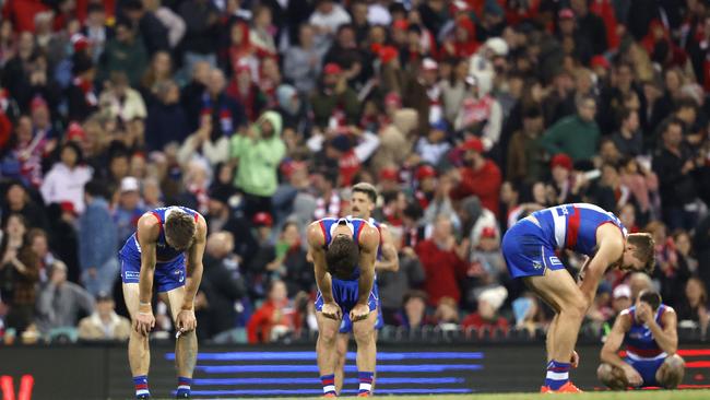 Bulldogs players lament a loss to Sydney.