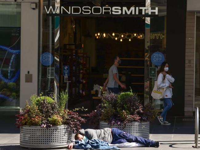 A man sleeps in Melbourne’s Bourke Street Mall. Picture: Ian Currie