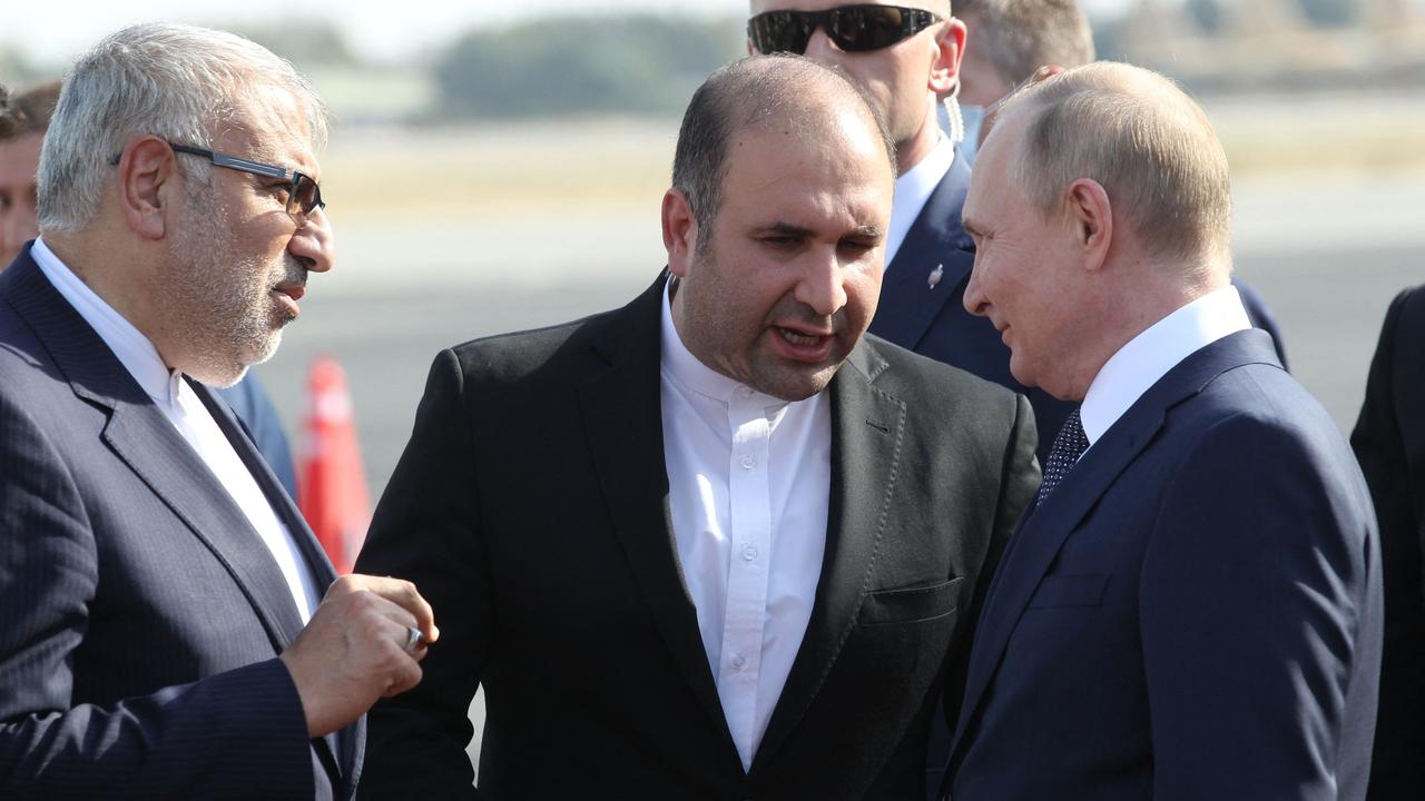 Russian President Vladimir Putin is welcomed by officials upon his arrival at the airport in Tehran. (Photo by Konstantin ZAVRAZHIN / SPUTNIK / AFP)