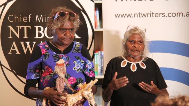 Tjanpi authors Elizabeth Dunn and Imuna Kenta accept the 2024 Chief Minister's book award for children's or young adult work on behalf of the Tjanpi Desert Weavers. Picture: Gera Kazakov