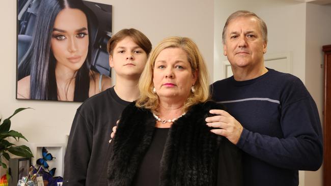 Fiona and Mark Pearce with son Josh, 14, in front of their daughter Bella's memorial, who was lost to suicide in January, Annerley. Picture: Liam Kidston