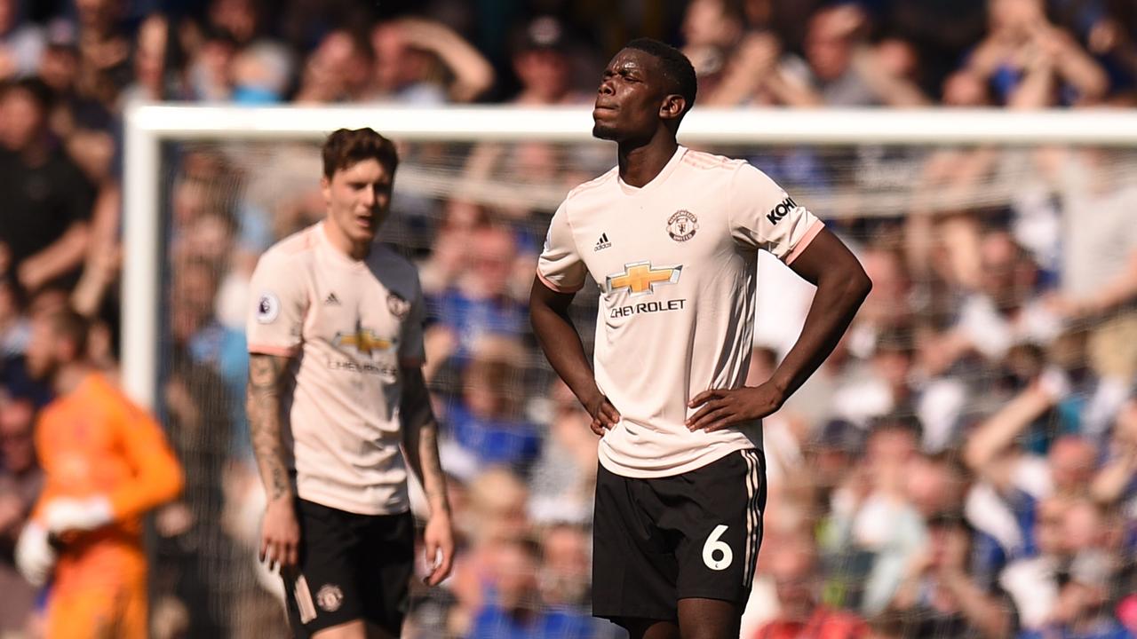 Manchester United's French midfielder Paul Pogba (R) reacts after Everton's fourth goal 