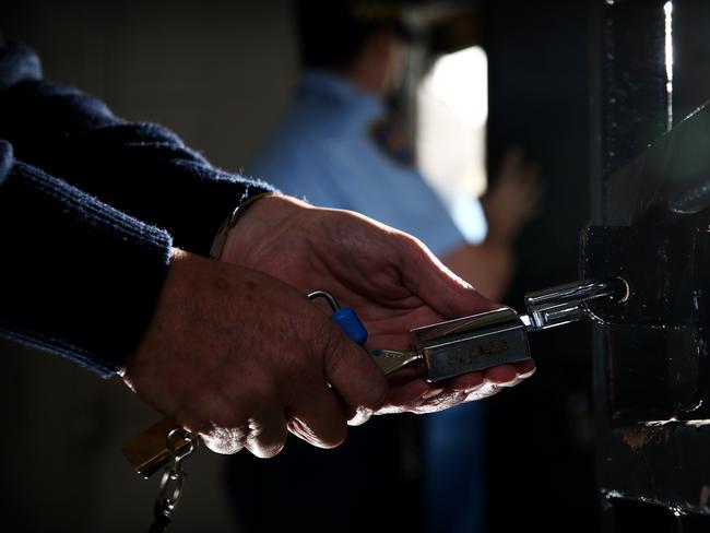 SUNDAY TELEGRAPH ONLY - Generic photo of hands opening a lock on a prison cell gate, at the Brush Farm Corrective Services training headquarters in Eastwood today. Picture: Tim Hunter.