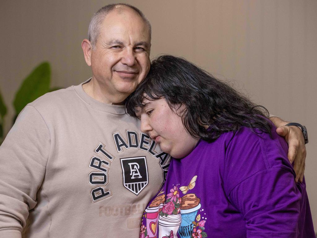 Georgia Kosteriadis with her dad Alex Kosteriadis at their home in seaton. They are on the verge of being evicted and bankruptcy after the NDIS cut two-thirds of their funding against the advice of doctors. Picture: Kelly Barnes