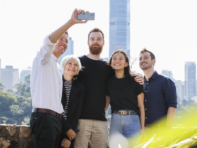 Greens MPs Max Chandler-Mather, Elizabeth Watson-Brown, and Stephen Bates take a selfie with fans Sam Woodman 24, and Julie Zhang 24, at Kangaroo Point. Picture Lachie Millard