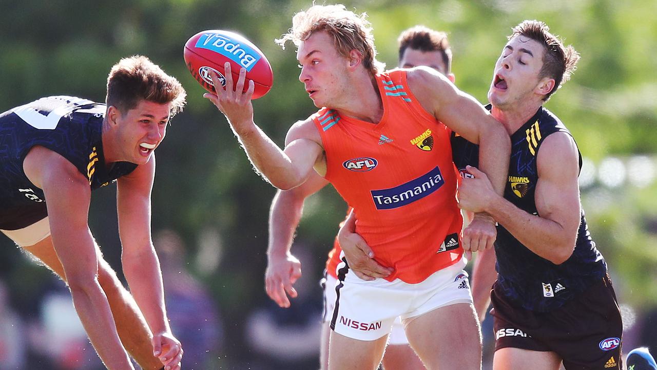 James Worpel is tackled by Daniel Howe and James Cousins.