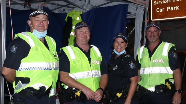 RELIEVED border checkpoint cops have posed for happy snaps with the last car that crossed the state line after it finally fully reopened on January 15. Picture Queensland Police