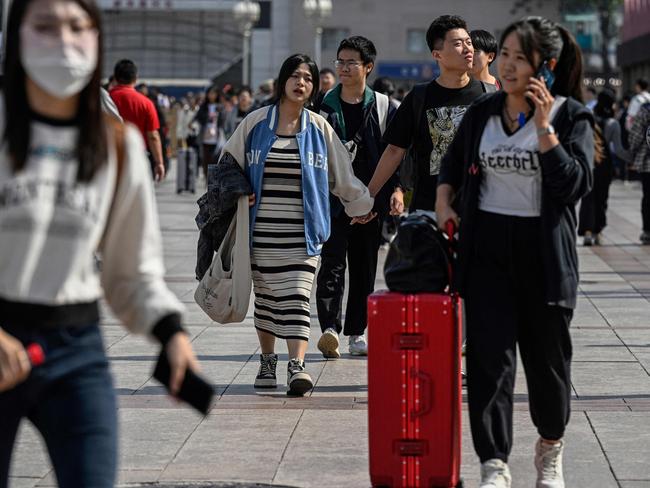 Passengers arrive at Beijing railway station on the first day of peak travel ahead of the National Day holidays in China's capital city on September 29, 2023. (Photo by Jade GAO / AFP)