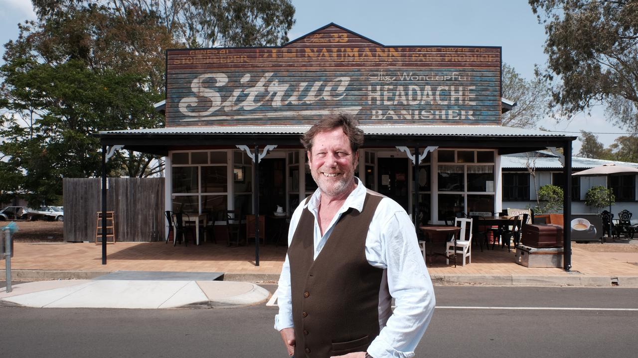 Daryl Moore out the front of Goombungee Antiques and Cafe. While re-roofing his business in 2019, builders stumbled across this advertising sign from the 1940s.