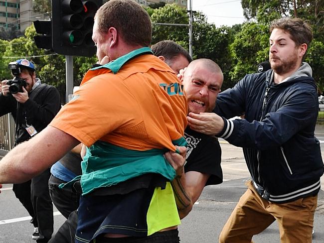 Protesters from opposing groups fight on the street outside Melbourne Pavilion. Picture: Jake Nowakowski