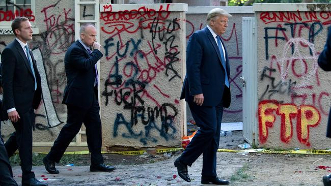 US President Donald Trump walks back to the White House escorted by the Secret Service after appearing outside a church during the week’s protests. Picture: AFP of St John's Episcopal church across Lafayette Park in Washington, DC on June 1, 2020. - President Donald Trump on June 3, 2020 denied media reports that he was rushed for his safety to the White House bunker while protests raged in the streets outside. (Photo by Brendan Smialowski / AFP)