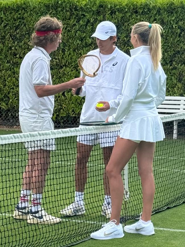 John McEnroe, dressed in his 80s attire, with Alex de Minaur and Katie Boulter at Wimbledon on Tuesday. The Australian did not train as he battles a hip injury.