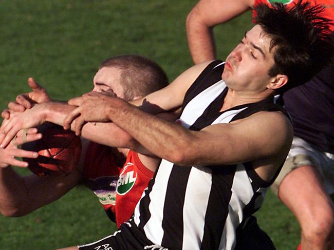 Nathan Longman of Glenorchy and his Hobart Demon opponent contest the ball at KGV in 2000.