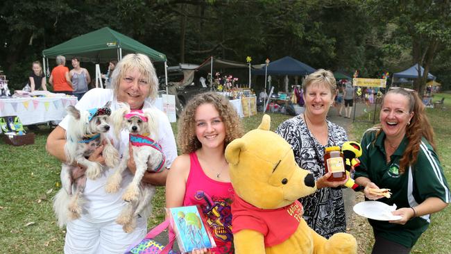 Redlynch community markets stall holders with some of the goods they are selling. Estelle Neilson from with Josef and Pixie wearing some gear from Snoottie dog designs, Nikita Howarth 13 with some toys, Tina Redmond from Buzzie Bee honey and organiser Emma Peacock. PICTURE: ANNA ROGERS