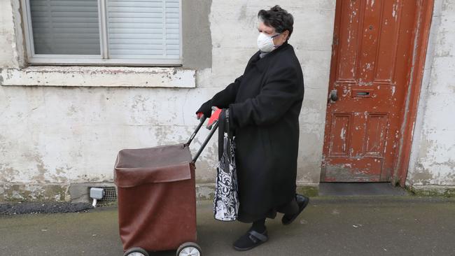 A woman heads to the shops in South Melbourne. Picture: David Crosling