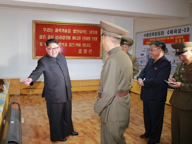 Kim, left, pictured during an August visit to the Chemical Material Institute of Academy of Defense Science. Picture: KCNA/AP