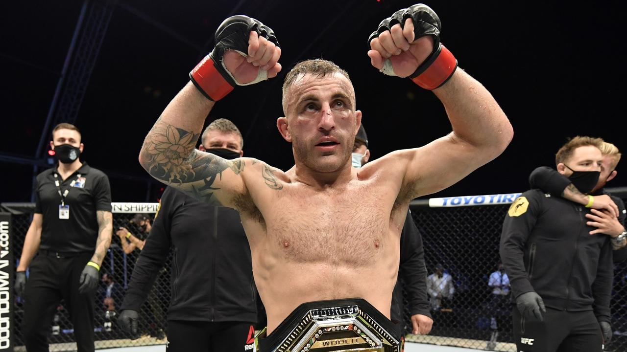 Alexander Volkanovski with his featherweight championship belt.