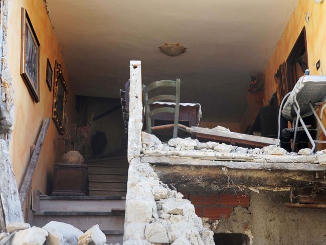 The quake ripped the facade off homes in seconds and in some properties phones could be heard ringing as loved ones called desparate for updates. Picture: AFP PHOTO / MARCO ZEPPETELLA