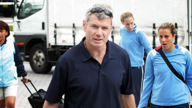 Former Matildas coach Adrian Santrac with members of his side at Perth Airport.