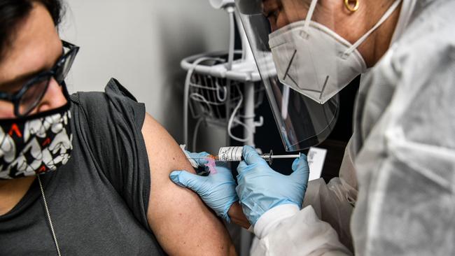 Heather Lieberman, 28, receives a COVID-19 vaccination from Yaquelin De La Cruz at the Research Centre of America in Hollywood, Florida. Picture: AFP