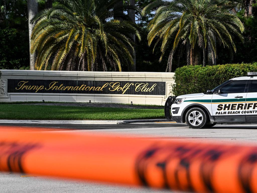 TOPSHOT - A Sherrif block the street outside the Trump International Golf Club in West Palm Beach, Florida, on September 15, 2024 following a shooting incident at former US president Donald Trump's golf course. Trump's campaign reported Sunday that there had been "gunshots in his vicinity" but added that the Republican presidential candidate was safe. (Photo by CHANDAN KHANNA / AFP)