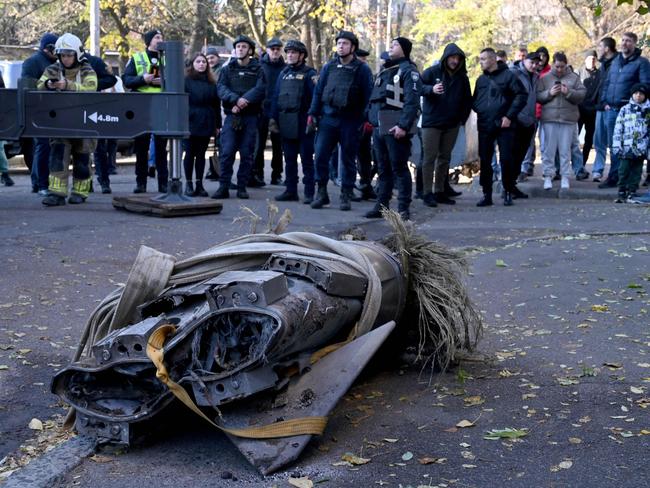 People look at the remains of a downed Russian hypersonic missile Zircon, after it struck a five-storey residential building in Kyiv during a "massive" aerial barrage. Picture: AFP